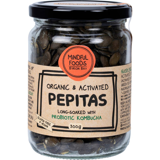 Jar of organic and activated pepitas with a label on a white background