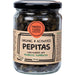 Jar of organic and activated pepitas with a label on a white background