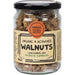 Jar of organic and activated walnuts with a label on a white background